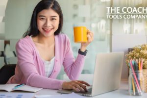 Happy Person at desk with Cup of Coffee